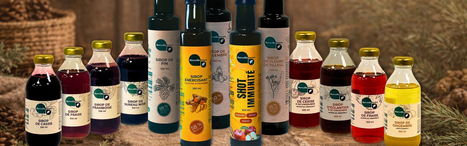 Assortiment de sirops bien-être, sirops traditionnels, shots naturels et jus artisanaux à base de plantes, présenté sur une table en bois dans une ambiance chaleureuse et naturelle.