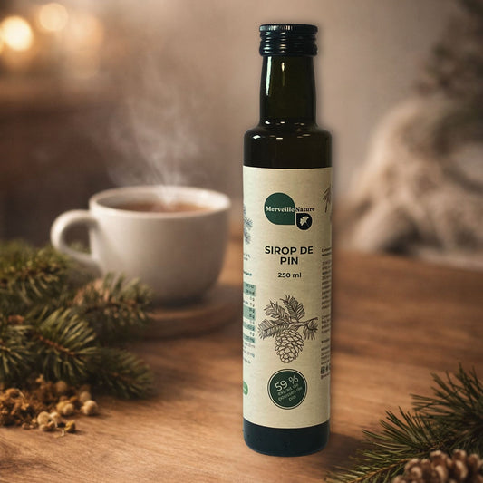 Bouteille de sirop de pin MerveilleNature posée sur une table en bois, avec une tasse de tisane chaude en arrière-plan et des branches de pin.